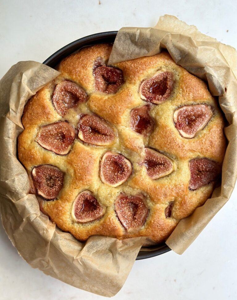 Homemade fig cake with fresh figs baked on top in a round pan