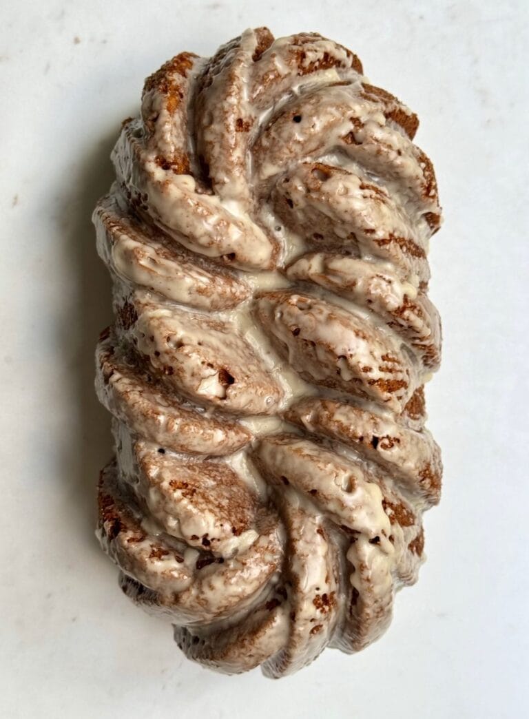 Cinnamon braided loaf with vanilla glaze on a white background.